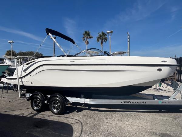 Bayliner DX 2200 2021 Bayliner DX 2200 boat on trailer, sunny day, palm trees in background.