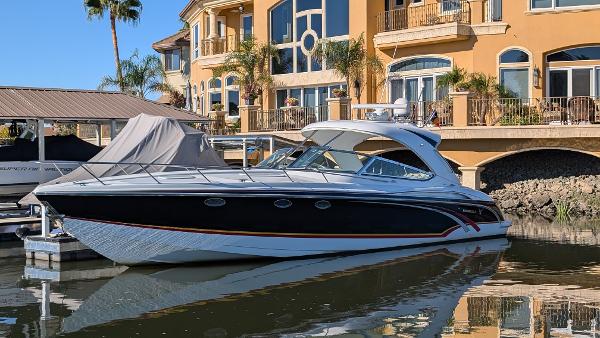 Formula 400 Super Sport & trailer 2007 Formula 400ss yacht docked by luxury waterfront homes.