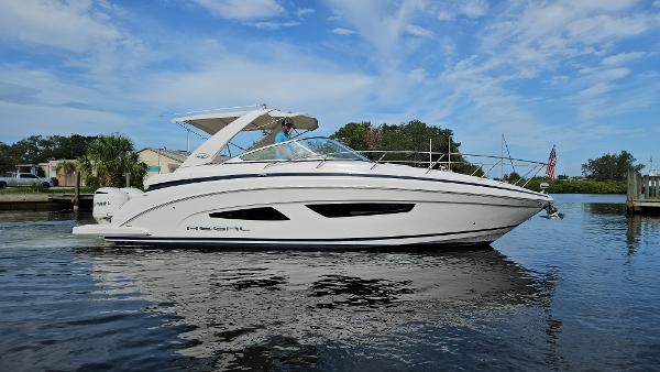 Regal 33 XO 2018 Regal 33 XO boat on calm water under a blue sky.