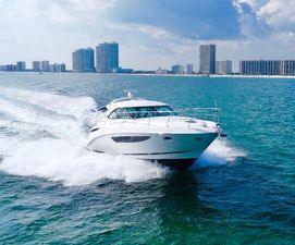 Sea Ray 410 Sundancer Sea Ray 410 Sundancer 2013 cruising on ocean near city skyline.