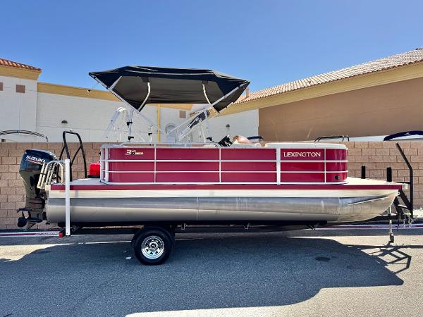 Lexington 321 CRUISE 2023 Lexington 321 CRUISE pontoon boat with canopy, parked on trailer.