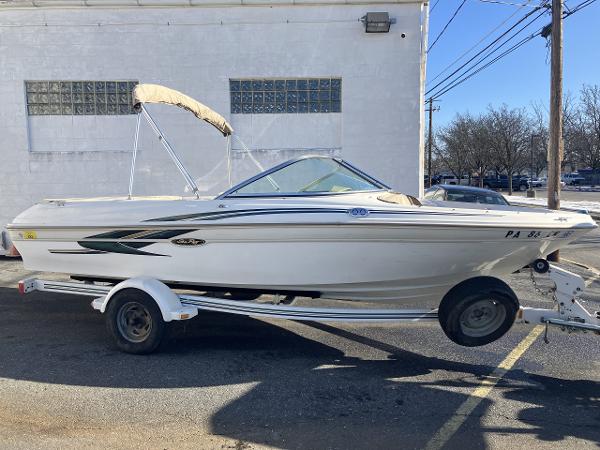 Sea Ray 180 Bow Rider 2001 Sea Ray 180 Bow Rider boat on trailer, parked outdoors.