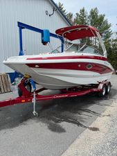 Crownline Eclipse E235 2023 Crownline Eclipse E235 boat on a red trailer, parked outdoors.