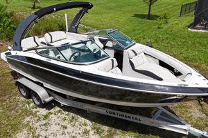 Regal 2300 Bowrider 2018 Regal 2300 Bowrider boat on trailer, parked on grass.