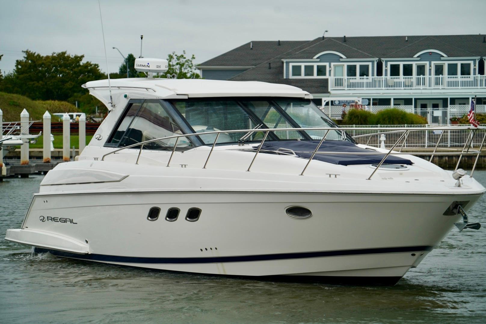 Regal 42 Sport Coupe 2012 Regal 42 Sport Coupe yacht docked near waterfront homes.