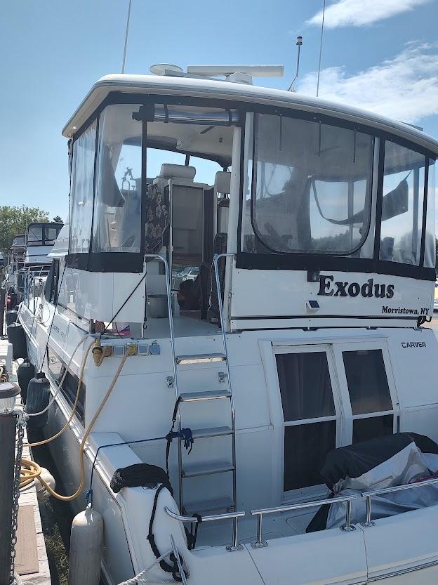 Carver 430 Cockpit Motor Yacht 1996 Carver 430 Cockpit Motor Yacht docked, featuring "Exodus" name on the stern.