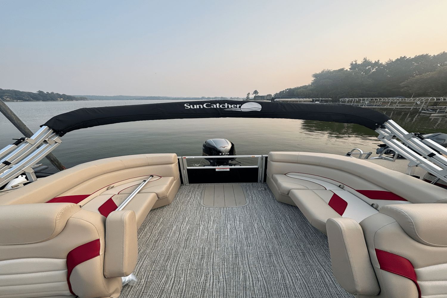 SunCatcher G3 SELECT 320RC 2023 SunCatcher G3 SELECT 320RC pontoon boat interior with beige and red seating on a calm lake.