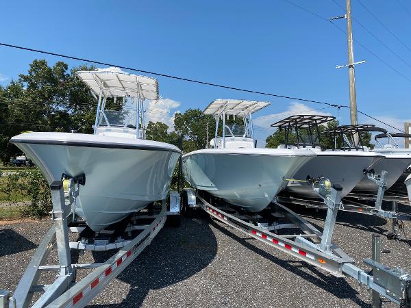Aquasport 2200 CC 2024 Aquasport 2200 CC boats on trailers, parked outdoors under clear skies.
