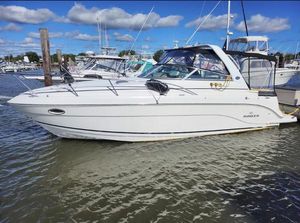 Rinker 300 Express Cruiser 2007 Rinker 300 Express Cruiser docked in a marina under blue skies.