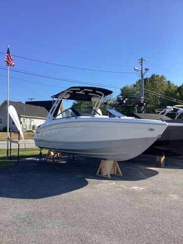 Cobalt R4 2026 Cobalt R4 boat displayed outdoors on stands, under clear blue sky.