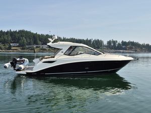 Sea Ray Sundancer 350 Coupe 2019 Sea Ray Sundancer 350 Coupe yacht on calm water, surrounded by trees.