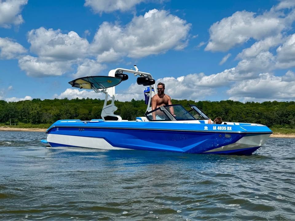 Nautique Super Air Nautique GS20 2023 Nautique Super Air Nautique GS20 boat on water, clear sky, and forest background.
