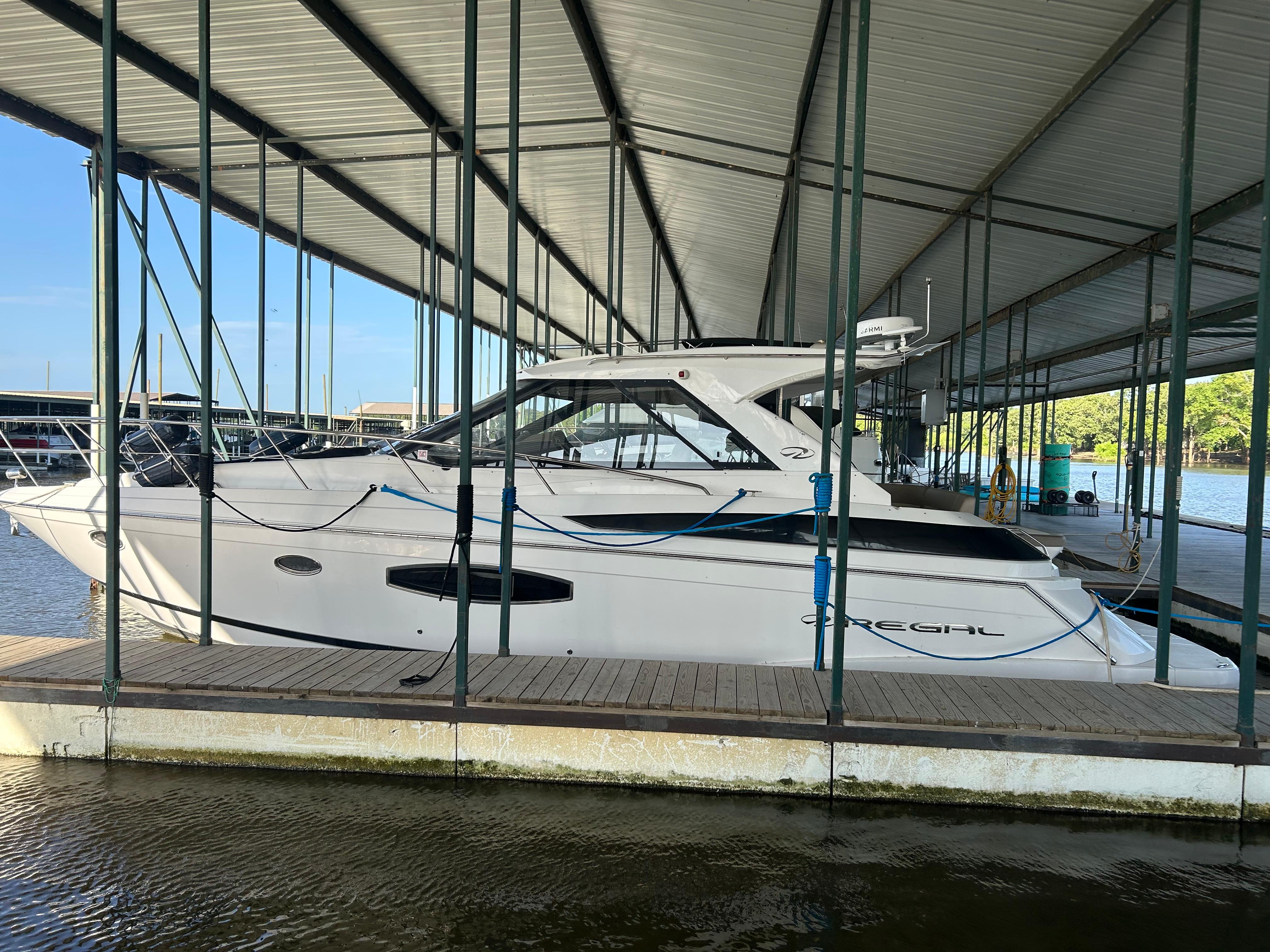 Regal 42 Sport Coupe 2014 Regal 44 Sport Coupe docked under covered marina.