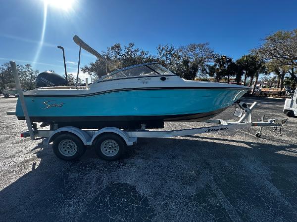 Scout 210 Dorado 2021 Scout 210 Dorado boat on trailer, parked outdoors under clear blue sky.