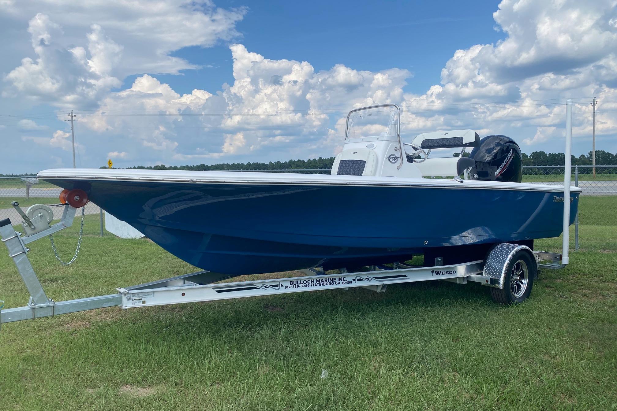 Tidewater 1910 Bay Max 2024 Tidewater 1910 Bay Max boat on trailer under cloudy sky.
