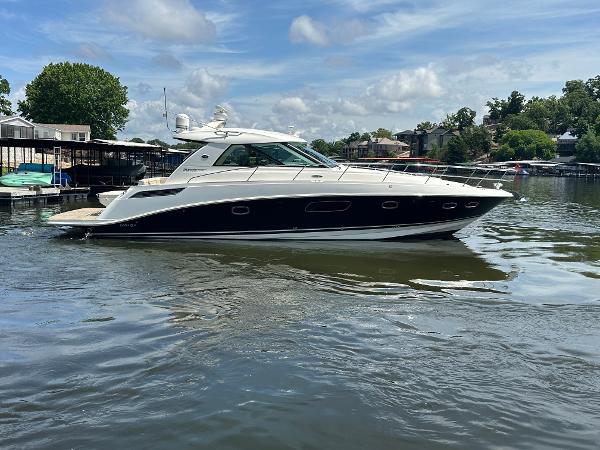 Sea Ray 450 Sundancer 2010 Sea Ray 450 Sundancer yacht on a calm lake under a partly cloudy sky.