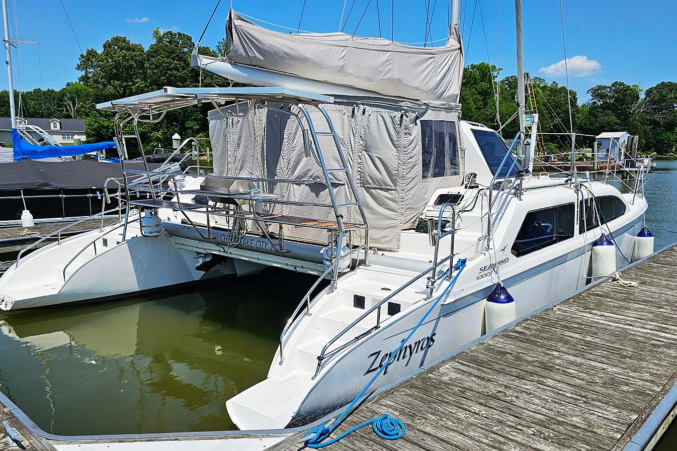 Seawind 36XL 2009 Seawind 36XL catamaran docked, featuring white hull and covered cockpit.