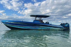 Statement 38 Blue 2023 Statement 38 boat on calm water under a partly cloudy sky.