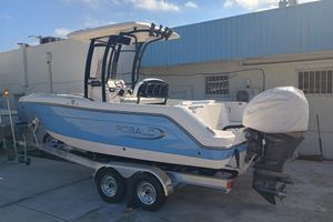 Robalo R222 Center Console 2026 Robalo R222 Center Console boat on trailer, blue and white design, parked outdoors.