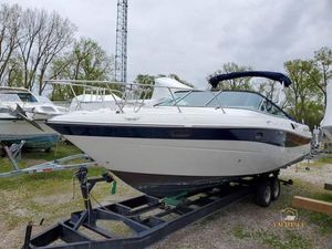 Four Winns 285 Sundowner 2000 Four Winns 285 Sundowner boat on trailer, parked outdoors.