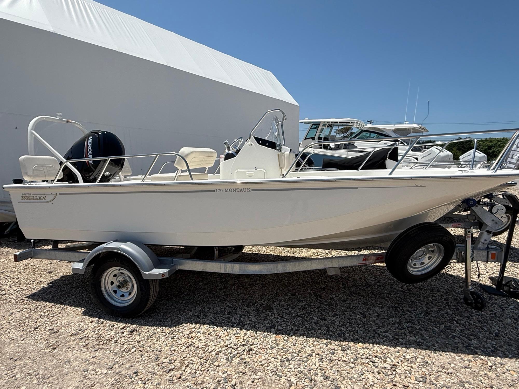 Boston Whaler 170 Montauk 2025 Boston Whaler 170 Montauk boat on trailer, displayed outdoors under clear sky.
