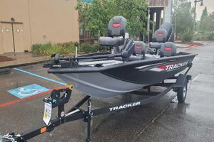 Tracker Pro Team 175 Crappie Edition 2026 Tracker Pro Team 175 Crappie Edition fishing boat on trailer in parking lot.