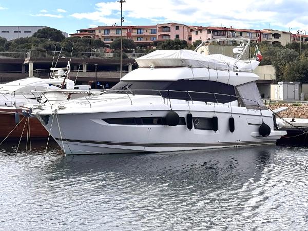 Prestige 500 2016 Prestige 500 yacht docked in a marina with scenic background.
