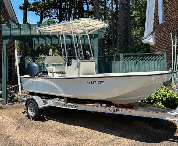 Boston Whaler 17 Montauk 2022 Boston Whaler 17 Montauk boat on trailer, parked in driveway.
