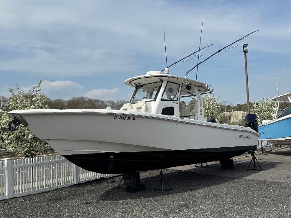 Solace 345 CC 2020 Solace 345 CC boat on display, white hull, parked outdoors.