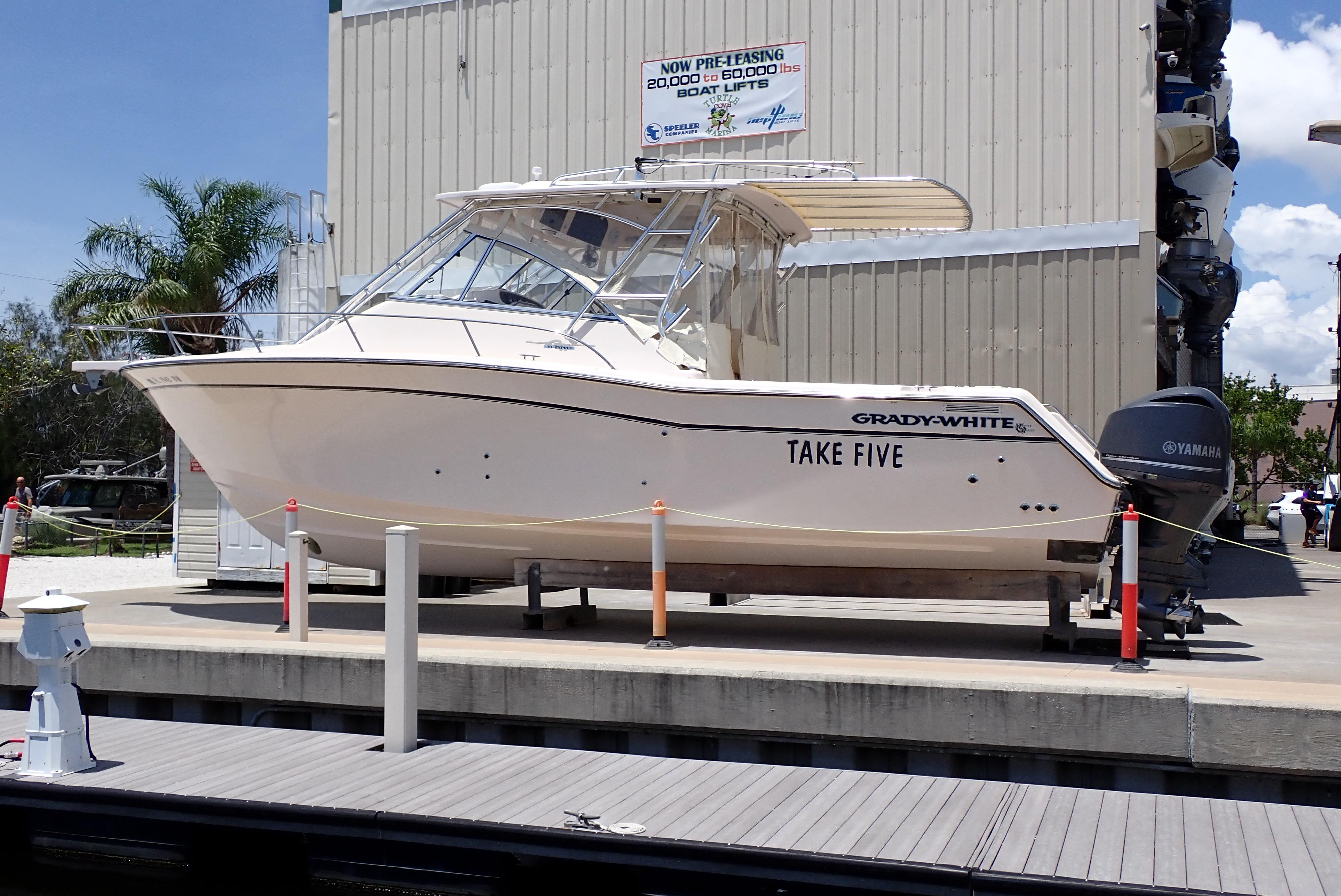Grady-White Express 330 2008 Grady-White Express 330 boat named "Take Five" on a lift at a marina.