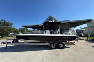 ShearWater 27 LTZ 2013 ShearWater 27 LTZ boat on trailer, parked outdoors under clear blue sky.