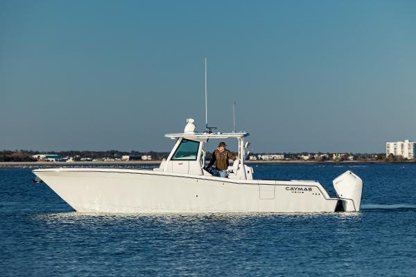Caymas 34 CT 2025 Caymas 34 CT boat cruising on calm water, clear sky background.