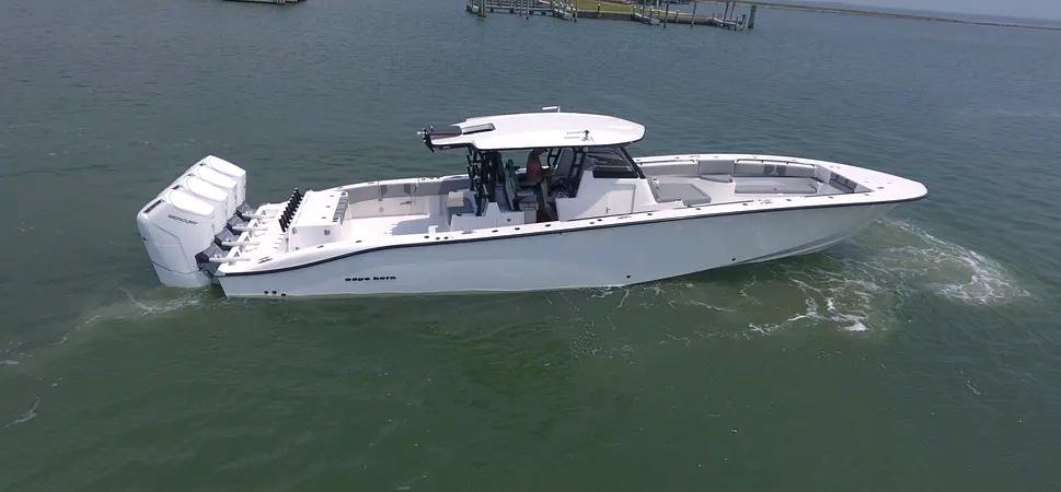 Cape Horn 47 CC 2025 Cape Horn 47 CC boat with triple outboard engines on calm water.