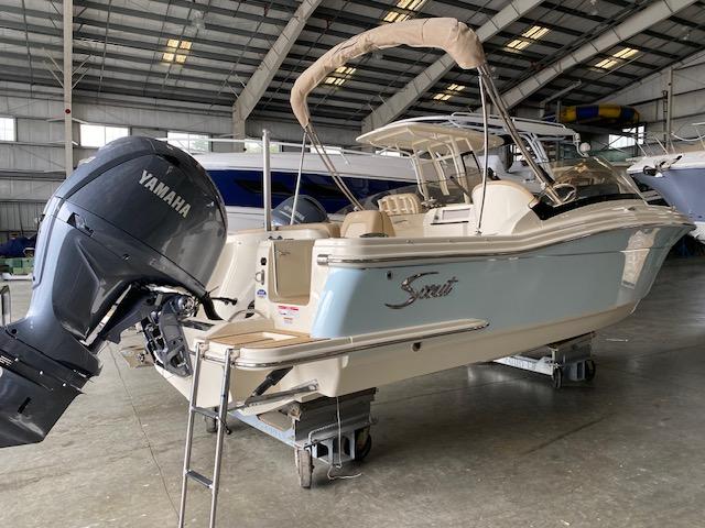 Scout 215 Dorado 2024 Scout 215 Dorado boat with Yamaha outboard motor in a warehouse.