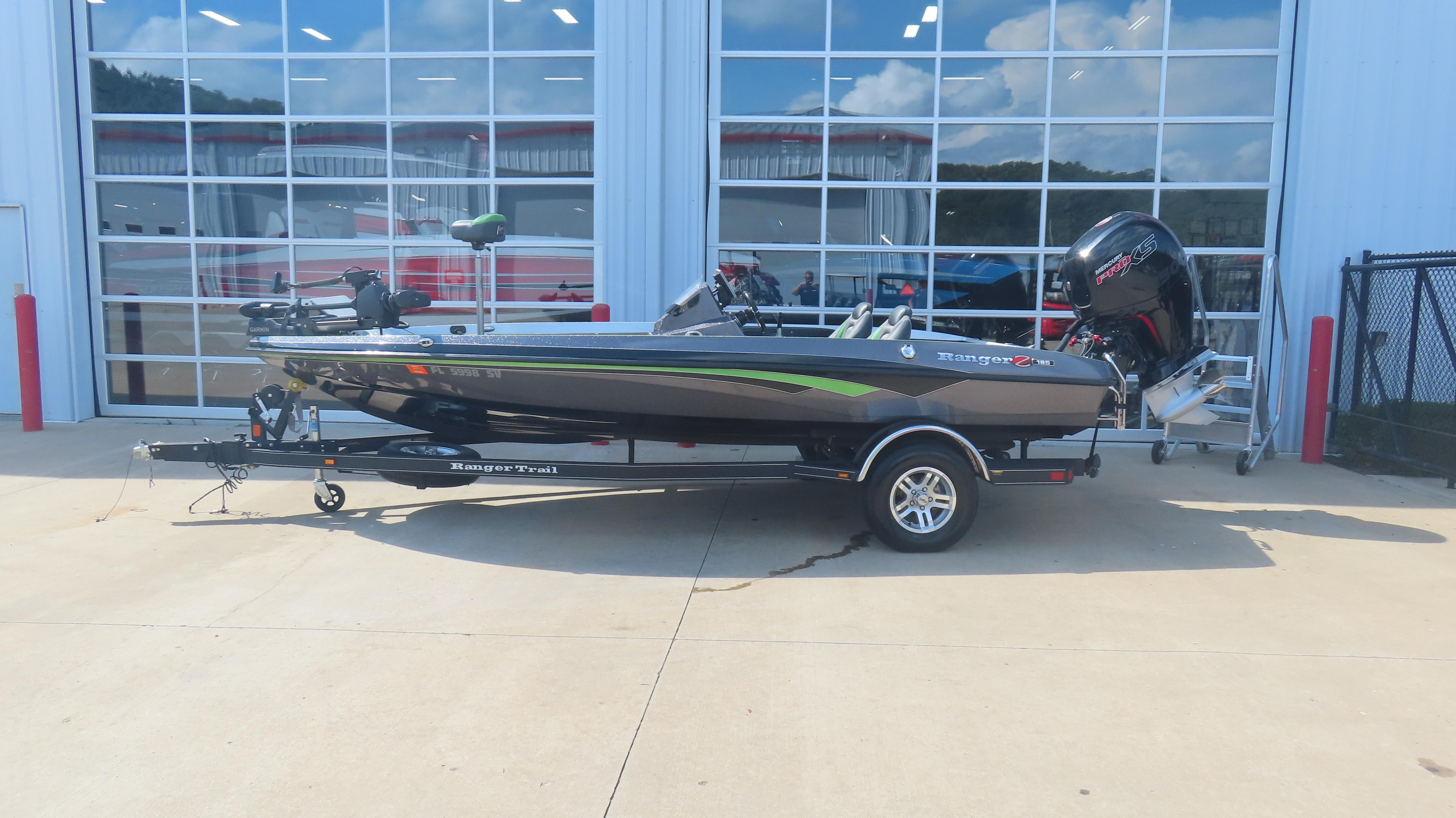 Ranger Z185 2019 Ranger Z185 boat with trailer, parked outside a building with glass doors.
