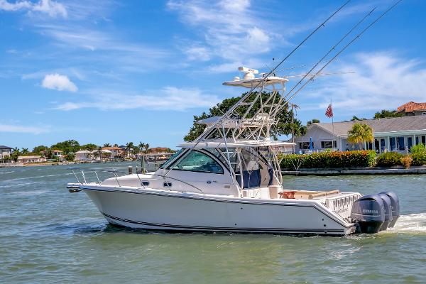 Pursuit OS 385 Offshore 2016 Pursuit OS 385 Offshore boat cruising on a sunny day near waterfront homes.
