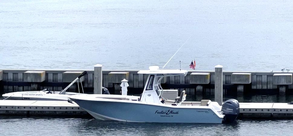 Tidewater 256 LXF 2022 Tidewater 256 LXF boat docked at marina with calm water background.