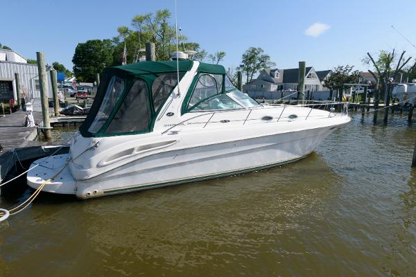 Sea Ray 340 Sundancer 2001 Sea Ray 340 Sundancer boat docked in a marina, featuring a green canopy.