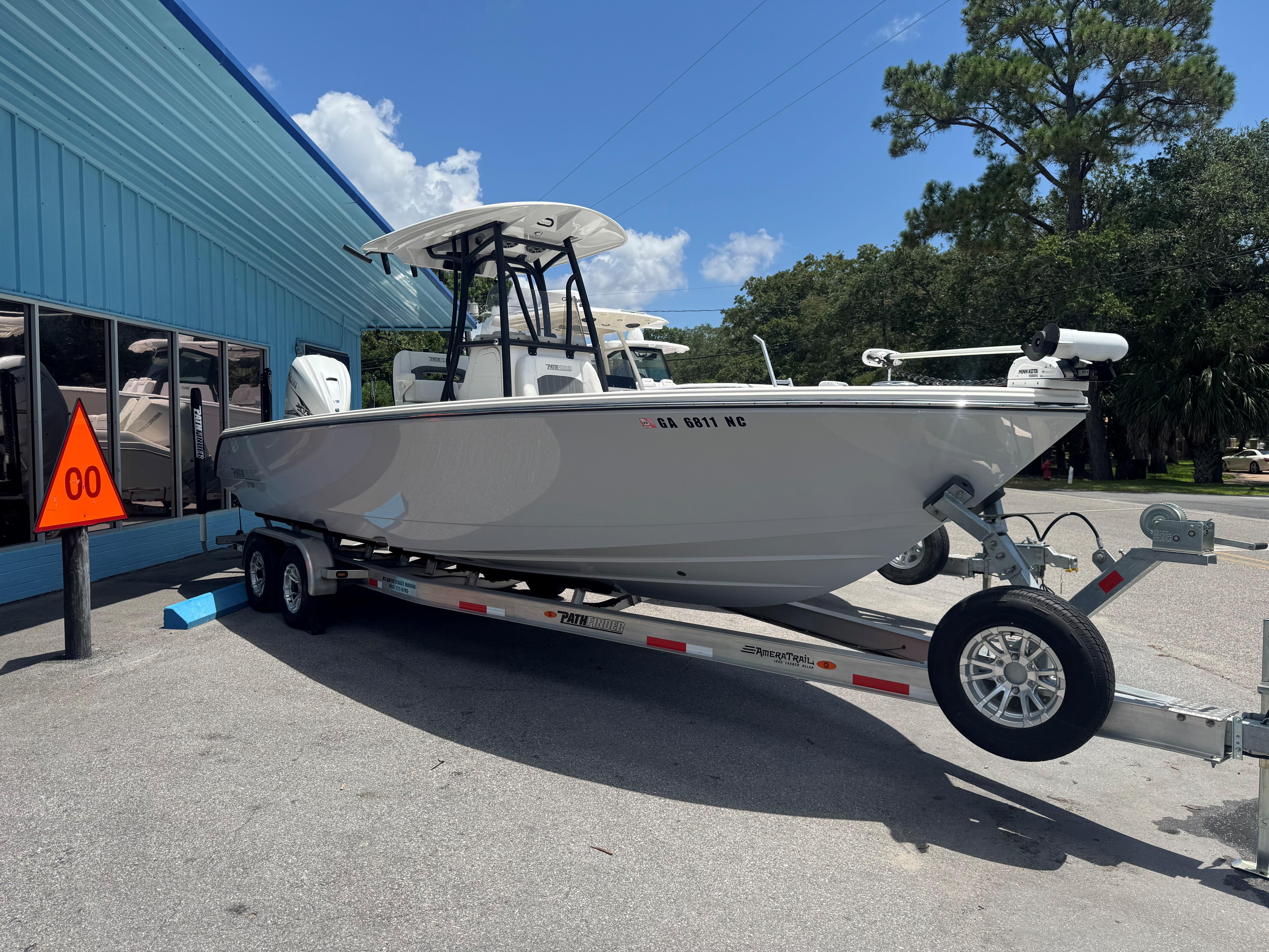 Pathfinder 2700 Open 2023 Pathfinder 2700 Open boat on trailer outside blue building.