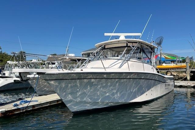 Grady-White Express 330 2008 Grady-White Express 330 boat docked in a marina under clear blue skies.