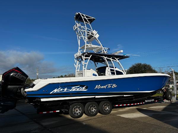 Nor-Tech 392 Superfish 2022 Nor-Tech 392 Superfish boat on a trailer, blue hull, triple outboard engines.