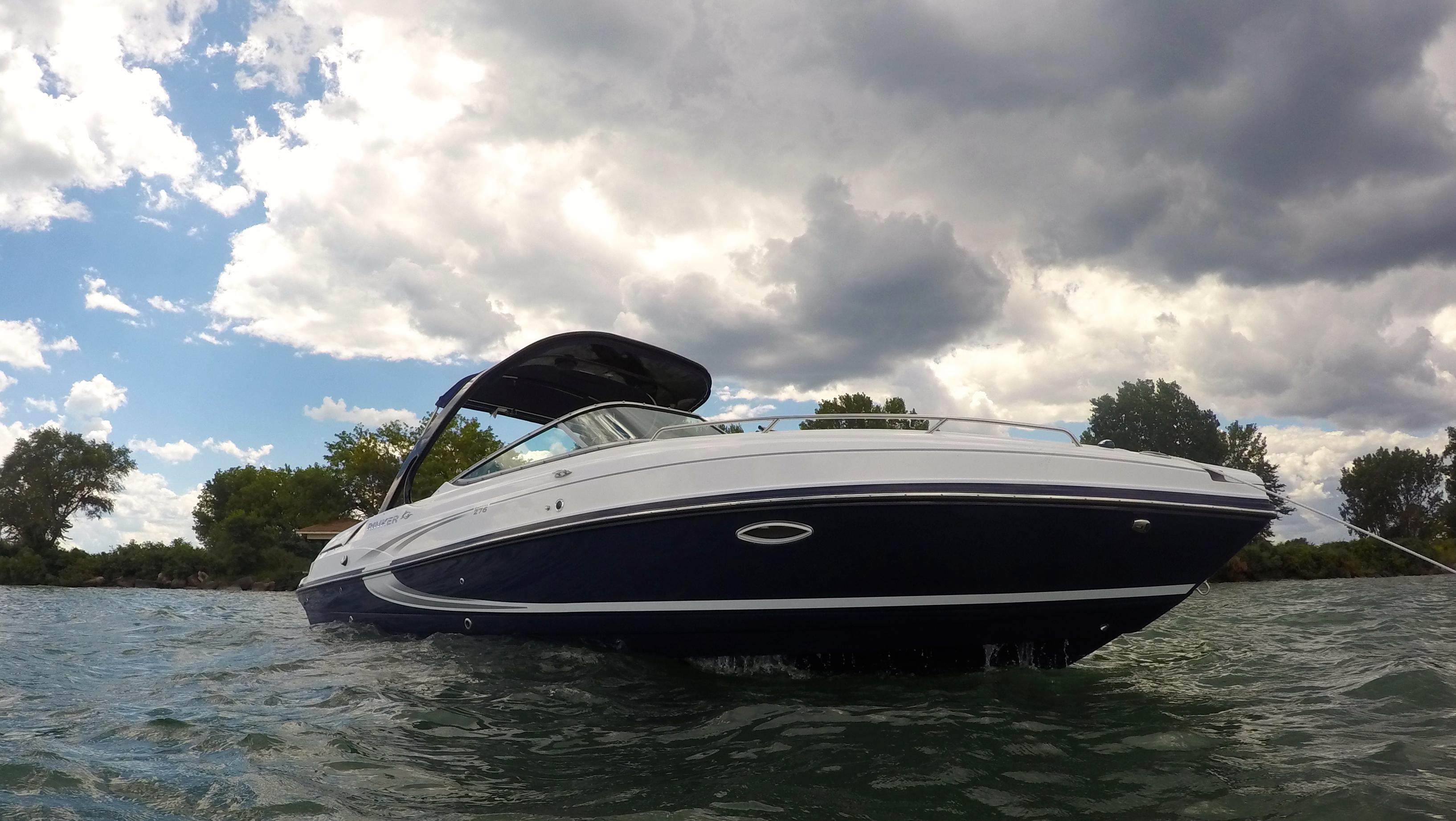 Rinker 276 Captiva Cuddy 2015 Rinker 276 Captiva Cuddy boat on water under cloudy sky.