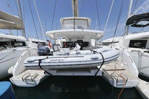 Lagoon 46 2022 Lagoon 46 catamaran with a Highfield tender docked at a marina.