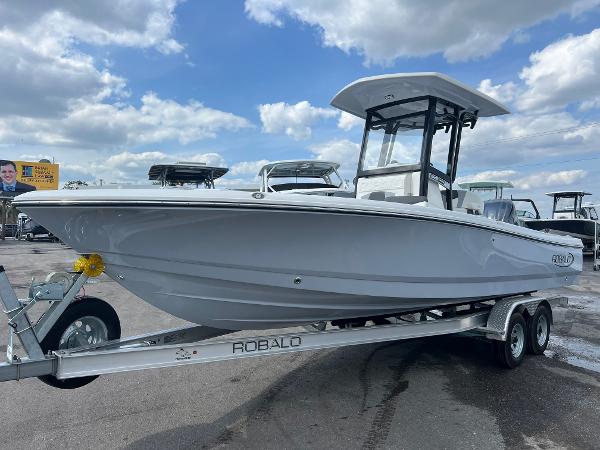Robalo 246 Cayman 2024 Robalo 246 Cayman boat on trailer under cloudy sky.