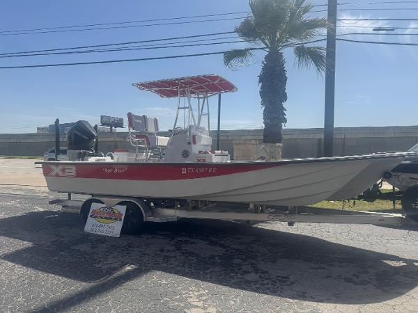 Shallow Sport 25 X3 2022 Shallow Sport 25 X3 boat on trailer, parked near palm tree.
