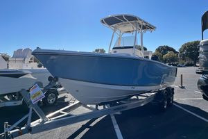 Mako 214 Center Console 2025 Mako 214 Center Console boat on trailer in parking lot.