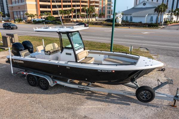 Everglades 273 CC 2019 Everglades 273CC boat on trailer, parked near a road with buildings in background.