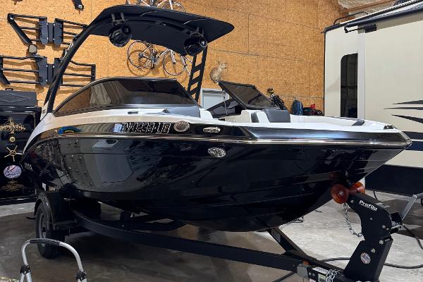 Yamaha Boats 195S 2024 Yamaha Boats 195S in a garage, sleek black design on trailer.
