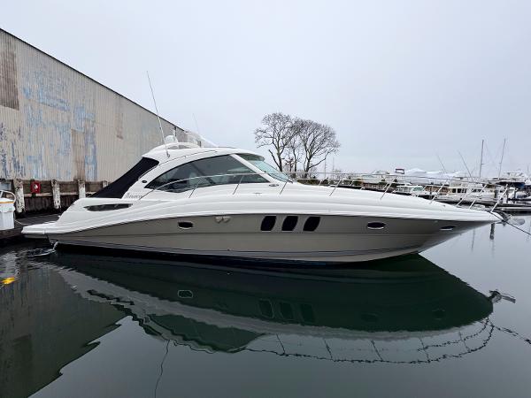 Sea Ray 48 Sundancer 2006 Sea Ray 48 Sundancer yacht docked in a marina, overcast sky.