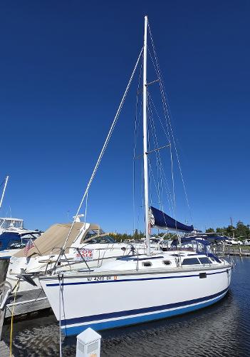 Hunter 33.5 1994 Hunter 33.5 sailboat docked at marina under clear blue sky.